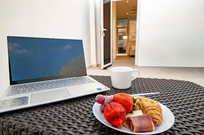 a plate of fruit on a table next to a laptop at Couples PH @ Cana Rock Star with Great Golf Views in Punta Cana