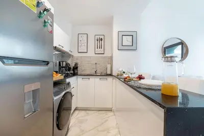 a kitchen with a refrigerator and a dishwasher at Couples PH @ Cana Rock Star with Great Golf Views in Punta Cana