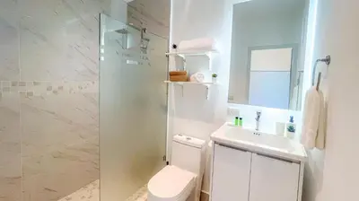 a bathroom with a toilet and a sink and a shower at Couples PH @ Cana Rock Star with Great Golf Views in Punta Cana