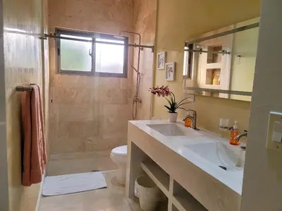 a bathroom with a sink and a shower and a toilet at Villa Olam in Las Galeras