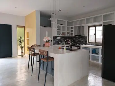 a kitchen with a kitchen island with chairs and a table at Villa Olam in Las Galeras
