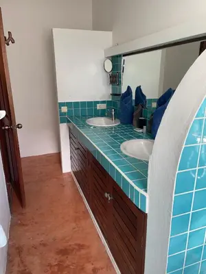 a bathroom with two sinks and a mirror at Villa Louana in Las Terrenas
