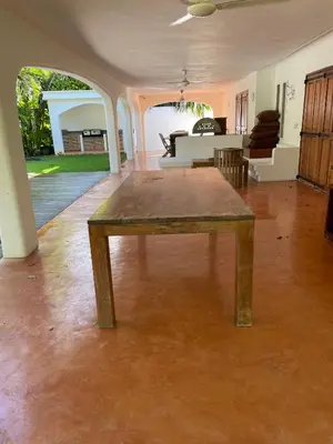 a wooden table in the middle of a living room at Villa Louana in Las Terrenas