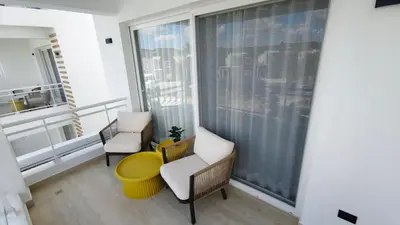 a balcony with two chairs and a window at Green Oasis in La Laguna