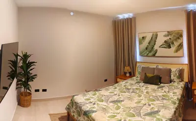 a bedroom with a bed and a plant in it at Green Oasis in La Laguna