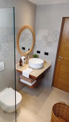 a bathroom with a sink and a toilet and a mirror at Green Oasis in La Laguna