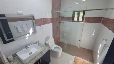 a bathroom with a sink and a toilet and a shower at Villa soñada 1 in Sosua