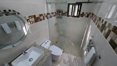 a bathroom with a sink and a toilet and a mirror at Villa soñada 1 in Sosua