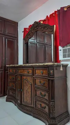 a wooden dresser with a mirror on top of it at Garden Mar in Bonao