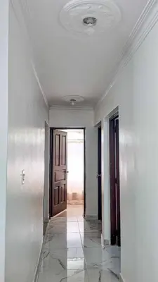 an empty hallway with a door and a tile floor at Garden Mar in Bonao