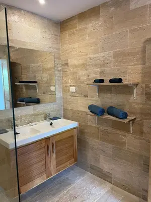 a bathroom with a sink and a mirror at Jardines de Montserrat - Lux, Rooftop, 3Bds, near beach in Las Terrenas