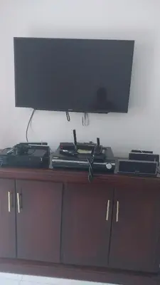 a television on top of a wooden cabinet at This beautiful apt you can have a nice vacation in Santo Domingo