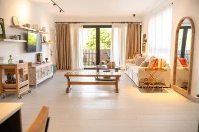 a living room with a couch and a table at Modern & Cozy Luxury Suite with Amazing Views of STI in Santiago de los Caballeros