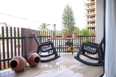 a balcony with two chairs and a fence at Modern & Cozy Luxury Suite with Amazing Views of STI in Santiago de los Caballeros
