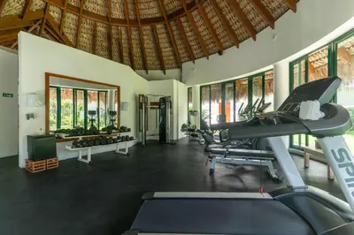 a fitness room with a gym with tread machines at Beachfront Sublime Las Terrenas in Las Terrenas