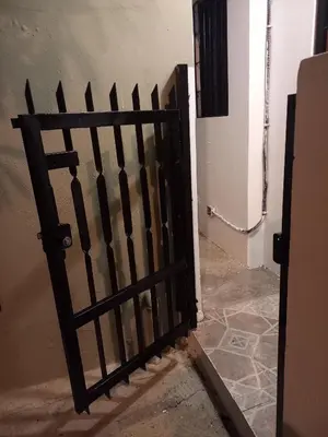 a black gate in a hallway with a door at Casa Petter and Maria, 2end floor in Santiago de los Caballeros