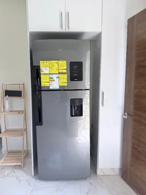 a refrigerator freezer sitting inside of a room at Villa Rafael in Bayaguana
