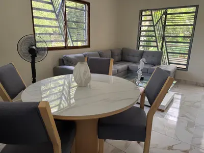 a living room with a table and chairs and a couch at Villa Rafael in Bayaguana