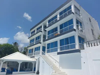 a white building with stairs and balconies on it at Villa Maryluz in Alto de los Castillos