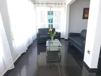 a living room with a couch and a glass coffee table at Villa Maryluz in Alto de los Castillos