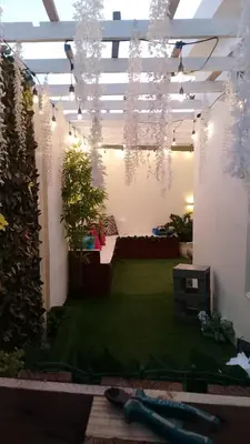 a room with a garden with plants and lights at Hotel a 500 de la playa in Pedernales