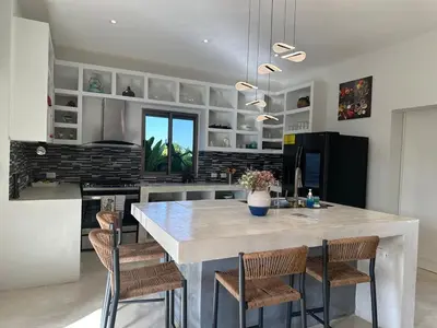 a kitchen with a large white table and chairs at Villa Olam - 9 pax, 4 min de la playa in Las Galeras