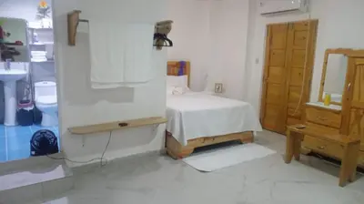 a bedroom with a bed and a dresser and a mirror at The Colonial Corner in Colorado