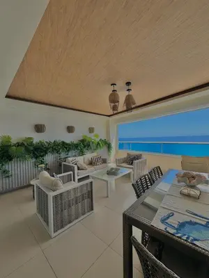 a living room with a view of the ocean at Las Olas Apartment, Juan Dolio in Guayacanes