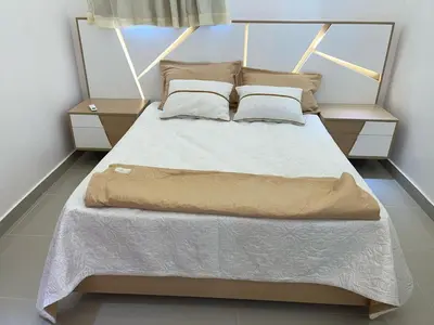 a bedroom with a large bed with two night stands at Apartment in the heart of Santiago in Santiago de los Caballeros