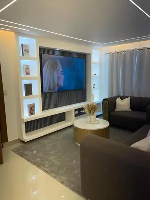 a living room with a flat screen tv in a living room at Apartment in the heart of Santiago in Santiago de los Caballeros