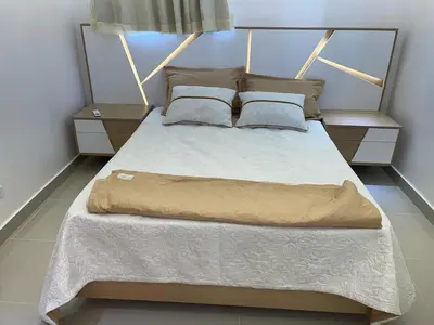 a bedroom with a large bed with two night stands at Apartment in the heart of Santiago in Santiago de los Caballeros