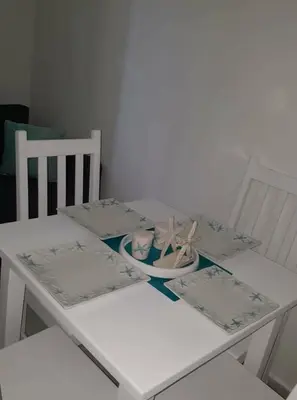 a white table with two chairs and a white table with a table at Private studio apartment with eat in kitchen in Bayahibe