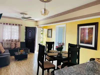 a living room with a table and a couch at Apt 2 Bedrooms a Pasos del Malecon y la Playa in San Felipe de Puerto Plata