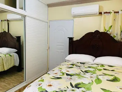 a bedroom with a bed and a mirror at Apt 2 Bedrooms a Pasos del Malecon y la Playa in San Felipe de Puerto Plata