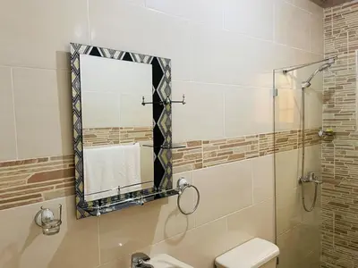 a bathroom with a mirror and a sink and a toilet at Apt 2 Bedrooms a Pasos del Malecon y la Playa in San Felipe de Puerto Plata