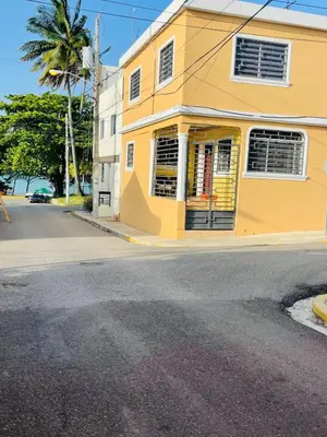 a yellow building on the side of a street at impecable 2 Bedroom Apartment Steps from the Pier in San Felipe de Puerto Plata