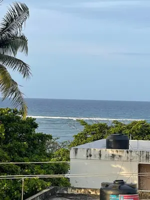 a view of the ocean from the balcony of a house at Luxurious 1BR apartment with ocean and mountain views, central in San Felipe de Puerto Plata