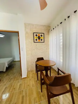 a room with a table and chairs and a bed at Luxurious 1BR apartment with ocean and mountain views, central in San Felipe de Puerto Plata