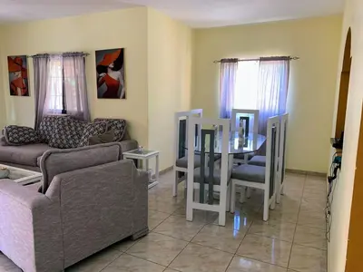 a living room with a couch and a table at Tu Casa En Pedernales in Pedernales