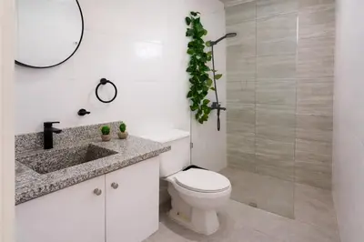 a bathroom with a toilet and a glass shower at Harmonia - Sunbeha resort, Juan Dolio in Juan Dolio