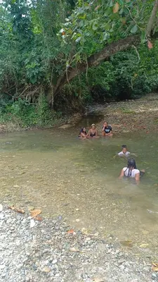 a group of people swimming in a river at las taranas villa tropical