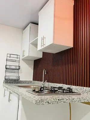 a kitchen with white cabinets and a sink at Sabor Latino Apartment in San Felipe de Puerto Plata