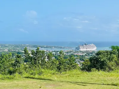 a cruise ship in the water with a city at Sabor Latino Apartment in San Felipe de Puerto Plata