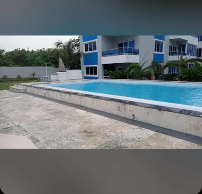 a large swimming pool in front of a building at Luxury Cabarete East Condominiums in Cabarete