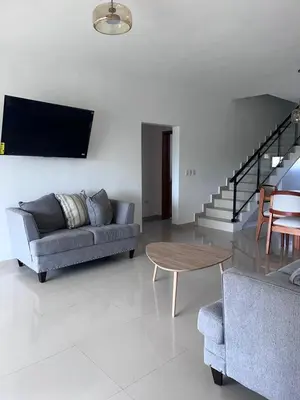 a living room with a couch and a table at jardines de caleta in La Romana