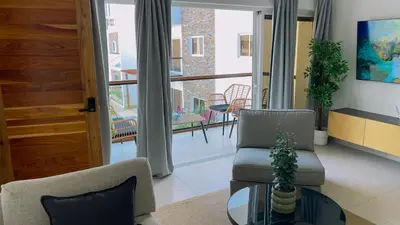 a living room with two chairs and a table and a balcony at Apartamento Armonía-K-204 in Las Terrenas