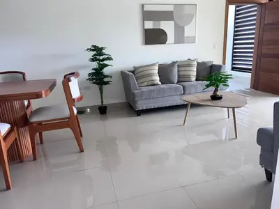 a living room with a couch and a table at jardines de caleta 7 in La Romana