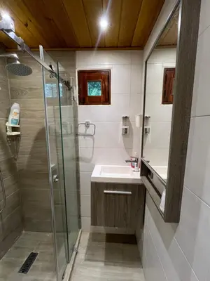 a bathroom with a shower and a sink at Villa refugio de paz in Bayaguana