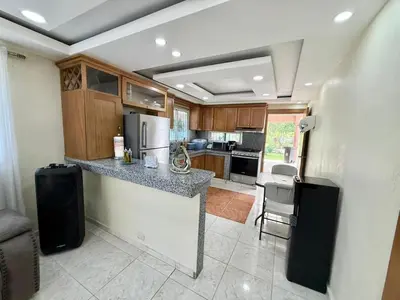 a kitchen with a counter with a refrigerator freezer at Charming villa in San Pedro de Macorís