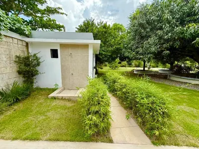 a small white house with a grass yard at Villa San Pedro in San Pedro de Macorís